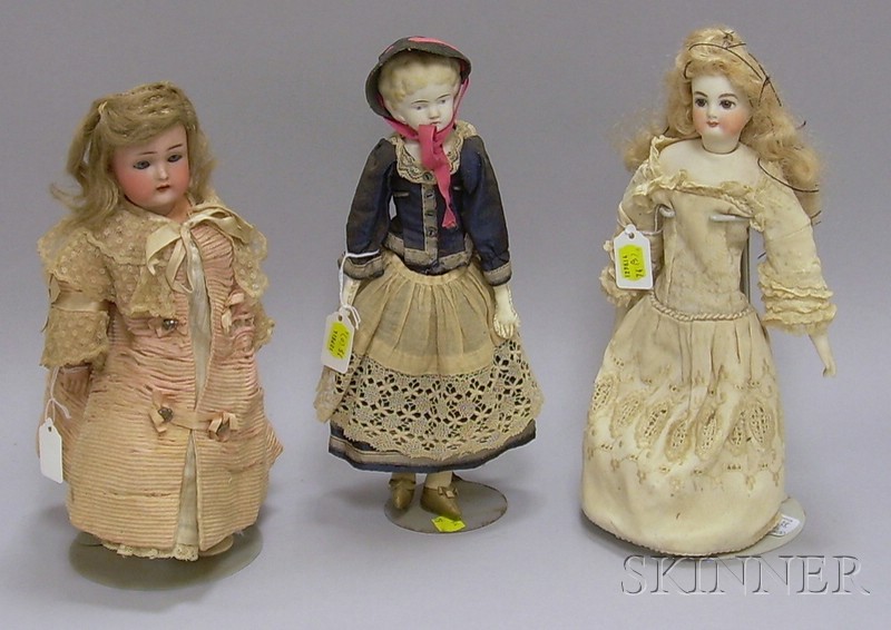 Appraisal: Two Small Blonde Dolls on Stands one porcelain with closed