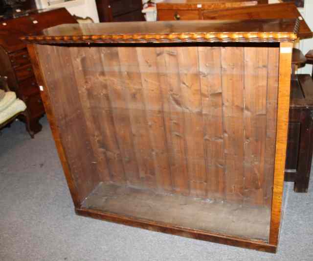 Appraisal: A VICTORIAN WALNUT OPEN BOOKCASE of simple form with stylised