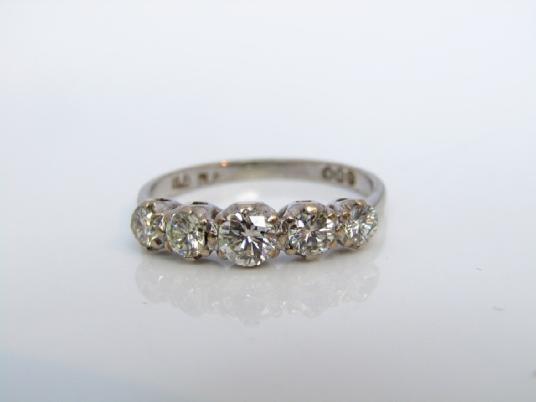 Appraisal: A five-stone diamond ring set with five graduated round brilliant-cut