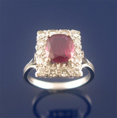 Appraisal: A ruby and diamond cluster ring the oval shaped ruby