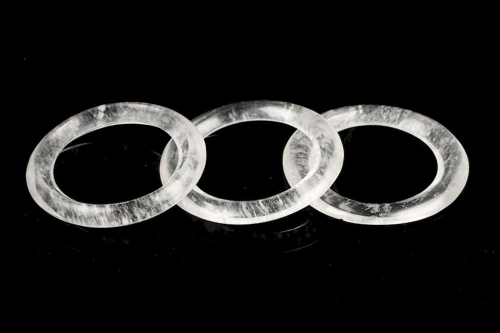 Appraisal: THREE CARVED ROCK CRYSTAL BI DISC RINGS A set of