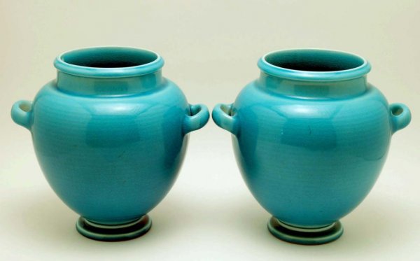 Appraisal: A pair of robin's egg blue handled art pottery urns