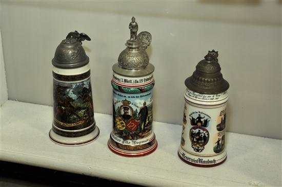 Appraisal: THREE LITHOPHANE STEINS German regimental steins with camping scenes domestic