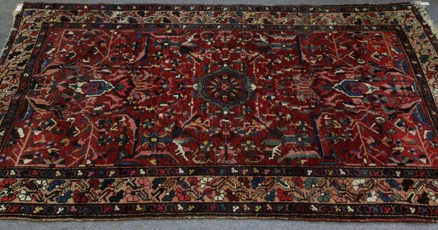 Appraisal: An Afghan rug with palmettes on a madder ground cm