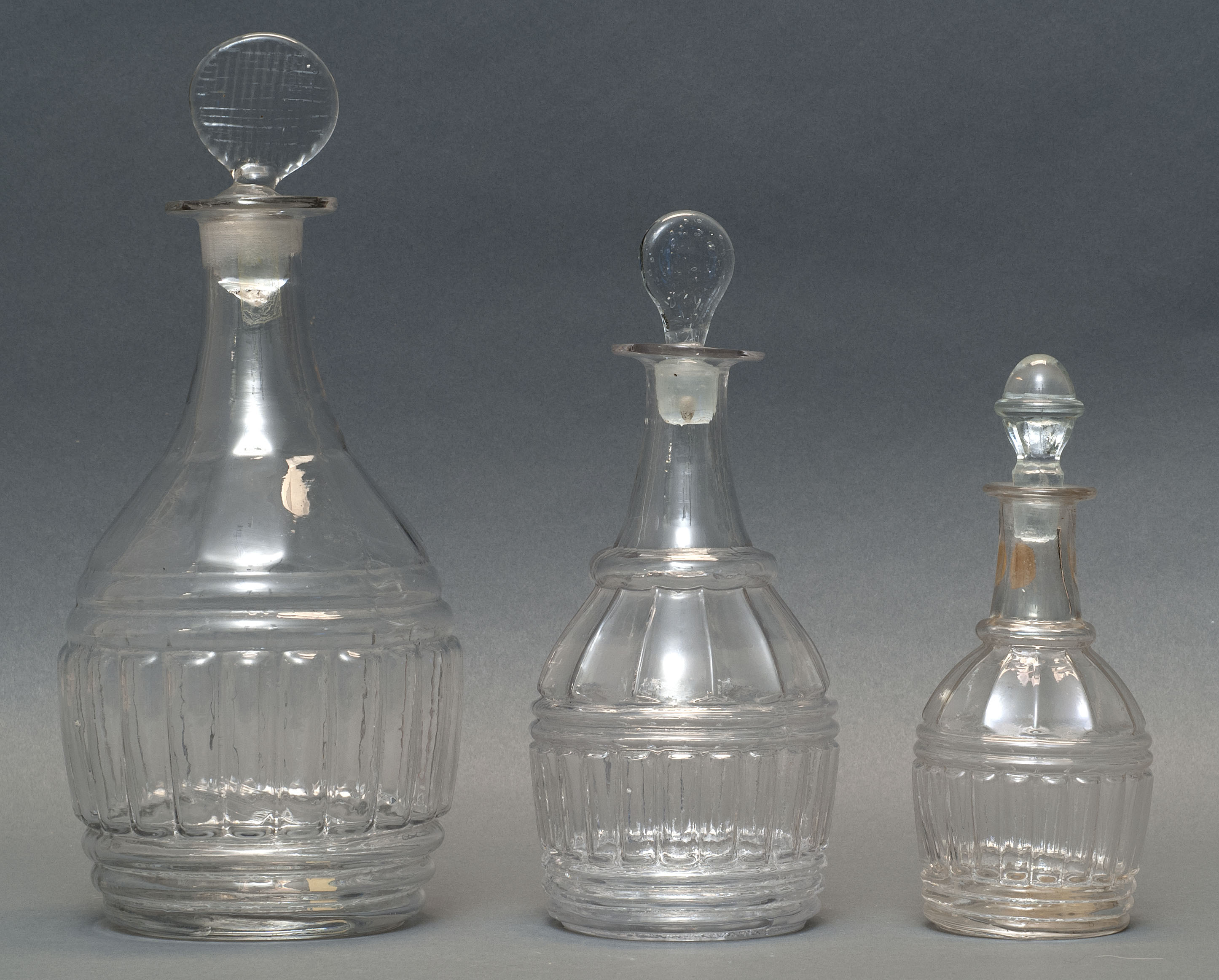 Appraisal: SET OF THREE CLEAR GLASS BLOWN -MOLD DECANTERS Second Quarter