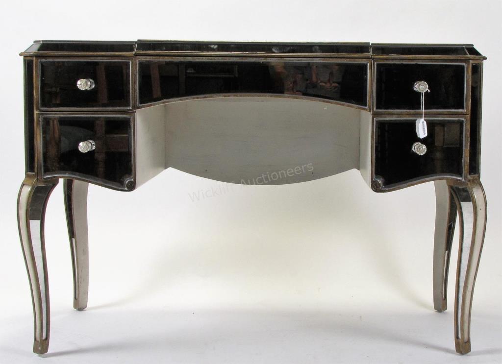 Appraisal: A vanity dresser with mirrored case drawers with hinged top