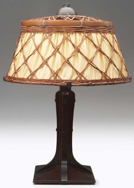 Appraisal: GUSTAV STICKLEY Table lamp with a corbeled oak base ringed