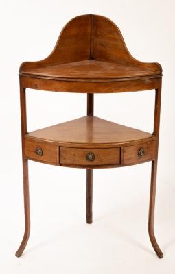 Appraisal: A Regency mahogany corner washstand with platform beneath on splay