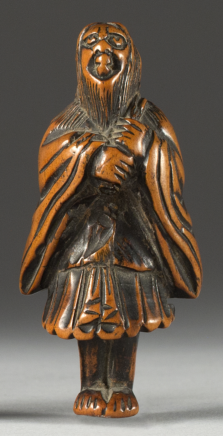 Appraisal: WOOD NETSUKE th CenturyIn the form of a standing sennin