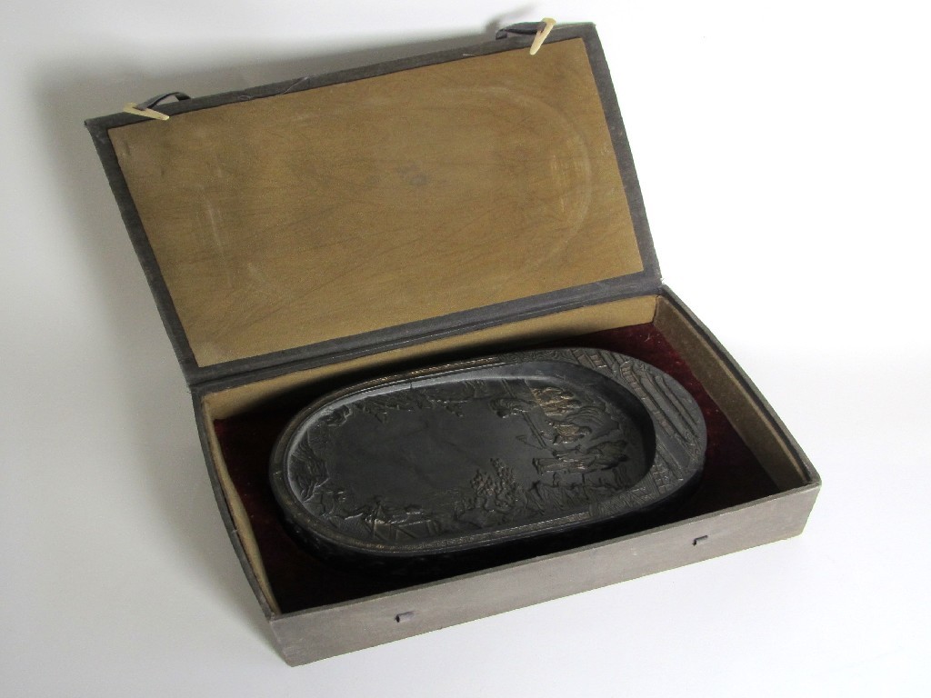 Appraisal: A Chinese oval ink block moulded with numerous figures cased