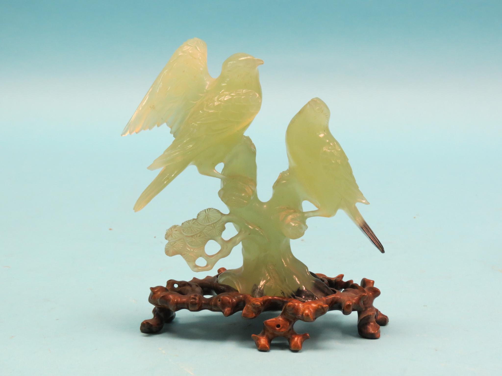 Appraisal: A carved green soapstone bird group on carved hardwood plinth