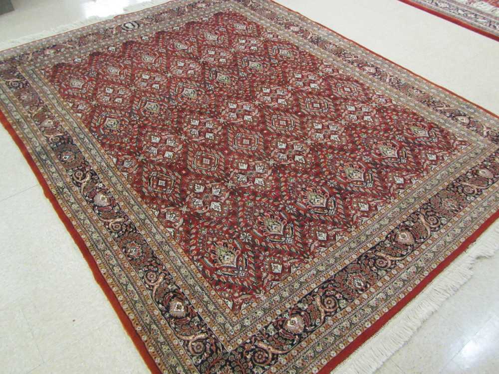 Appraisal: HAND KNOTTED ORIENTAL CARPET Indo-Persian repeating diamond-shaped floral panels on