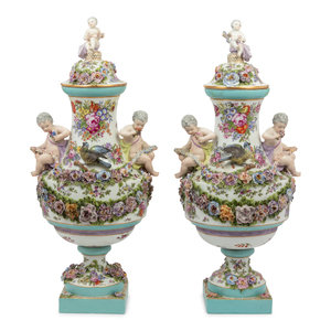 Appraisal: A Pair of Continental Porcelain Urns th Century each bearing