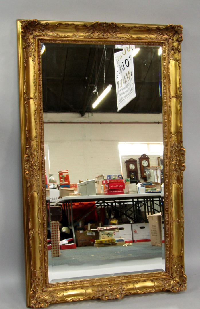 Appraisal: A rococo style gilt rectangular wall mirror modern inset bevelled