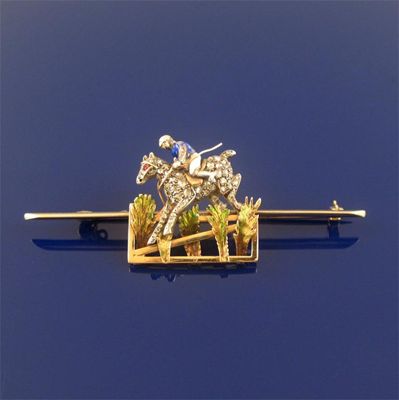 Appraisal: A jumping racehorse and jockey brooch the diamond set horse