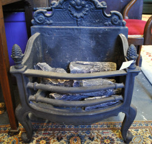 Appraisal: A cast iron fire basket with scrolling back and pine-cone