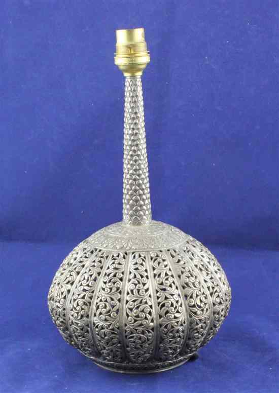 Appraisal: An Indian white metal table lamp with pierced bulbous body