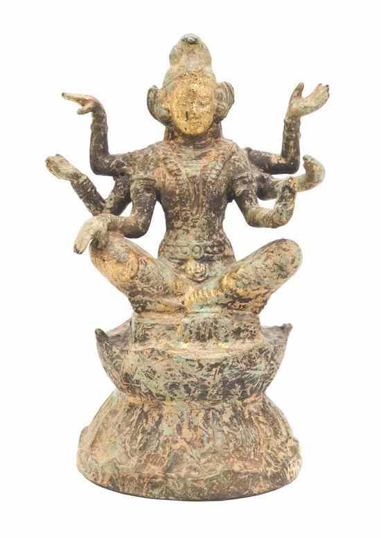 Appraisal: A Southeast Asian Figure of a Multi-Armed Deity retaining partial