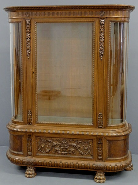 Appraisal: Walnut and glass bow-front china cabinet with a carved lower