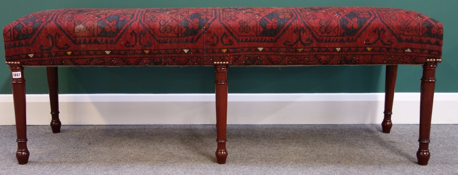 Appraisal: A large rectangular footstool with carpet upholstered seat on six