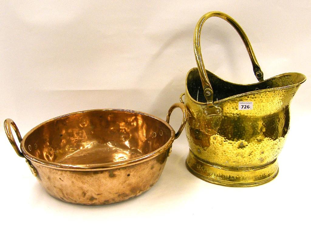 Appraisal: Brass planished helmet coal scuttle and a circular copper jam