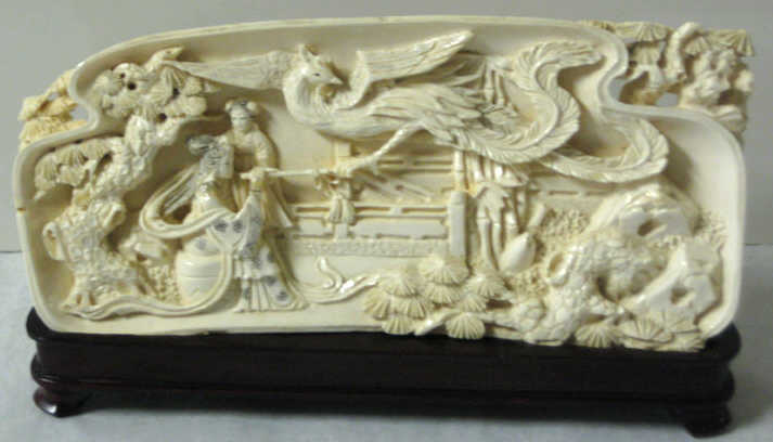 Appraisal: CHINESE CARVED IVORY PLAQUE Relief of two ladies with large