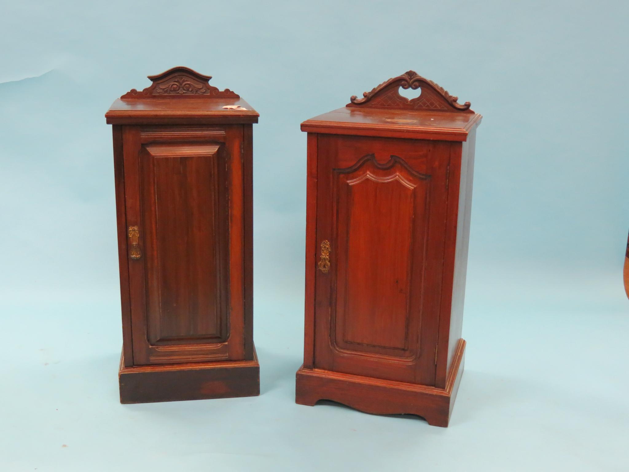 Appraisal: Two Victorian walnut bedside cupboards each with carved cresting enclosed