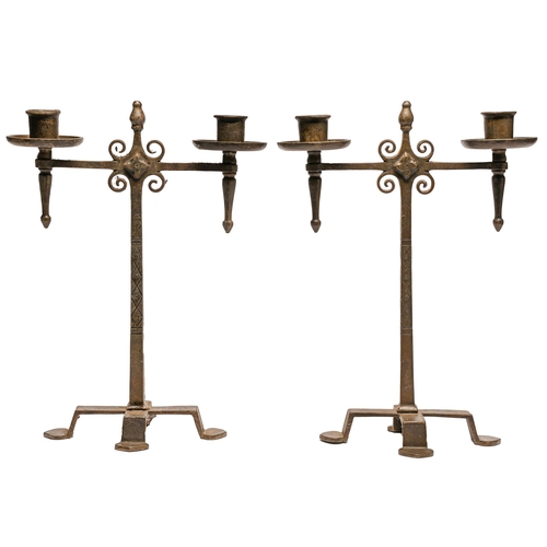 Appraisal: A pair of Arts and Crafts wrought iron candelabra of