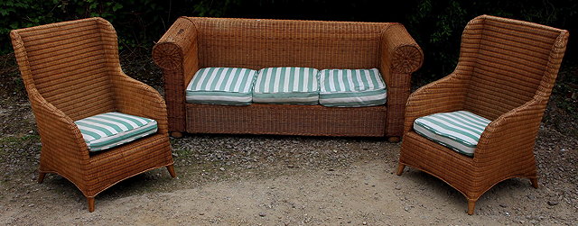 Appraisal: A WICKER CONSERVATORY SUITE consisting of a sofa with scroll