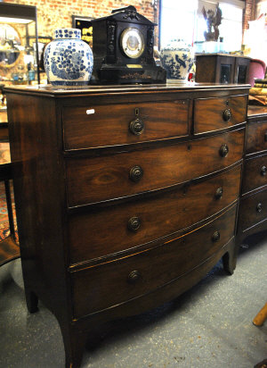 Appraisal: A George III mahogany bowfront chest of two short and