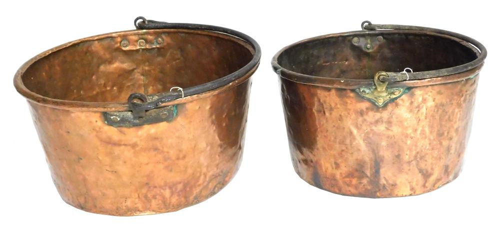 Appraisal: Two large hammered copper cauldrons with iron swing handles th