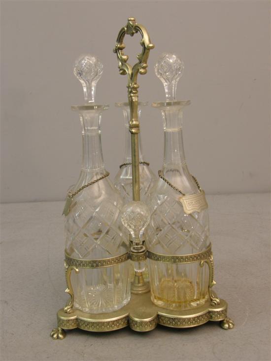 Appraisal: Silver plated three-bottle decanter holder with three cut glass decanters