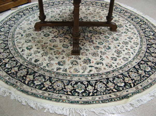 Appraisal: ROUND ORIENTAL CARPET Pakistani-Persian floral and central floral medallion design