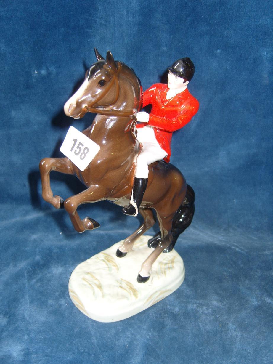 Appraisal: A Beswick model of a red jacketed huntsman seated on