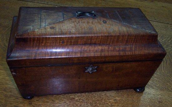 Appraisal: A late Regency mahogany sarcophagus shaped tea caddy the interior