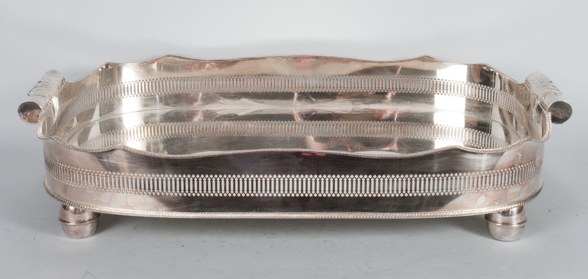 Appraisal: English silver-plated reticulated tray rolled handles bun feet x in