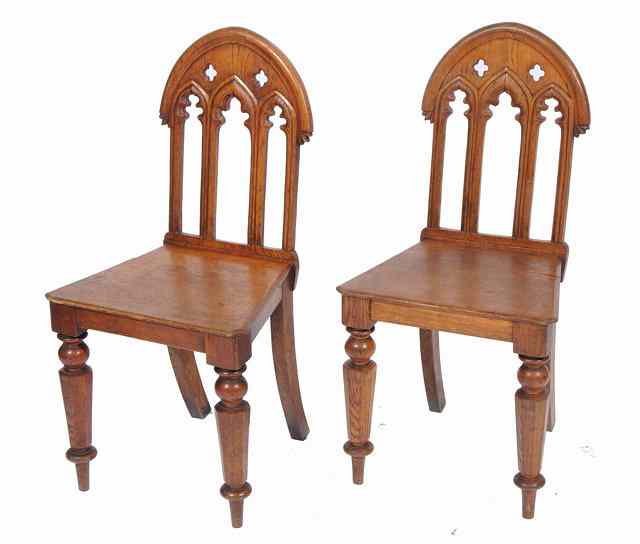 Appraisal: A PAIR OF VICTORIAN OAK HALL CHAIRS with Gothic style