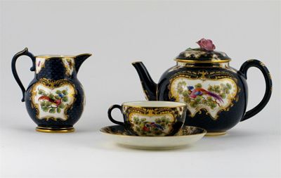 Appraisal: A Royal Worcester teapot and cover with matching milk jug