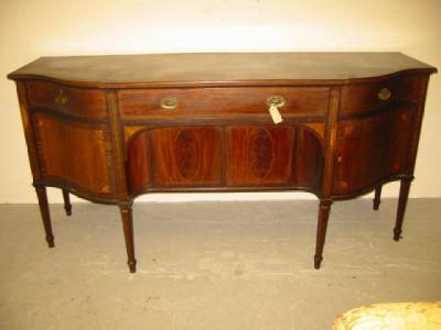 Appraisal: A MAHOGANY SIDEBOARD of breakfront form the moulded and dentil