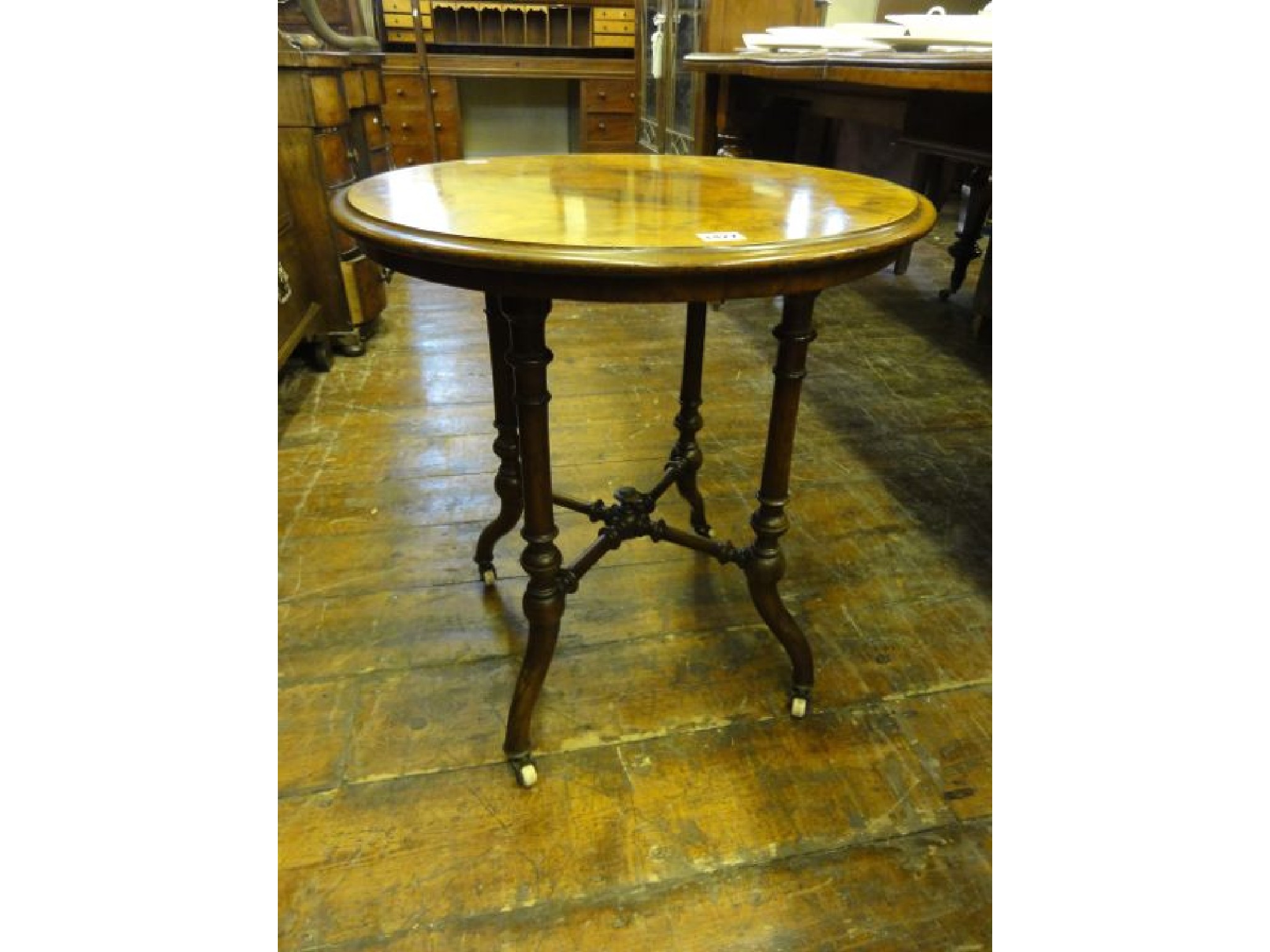 Appraisal: A Victorian walnut and figured walnut veneered occasional table of