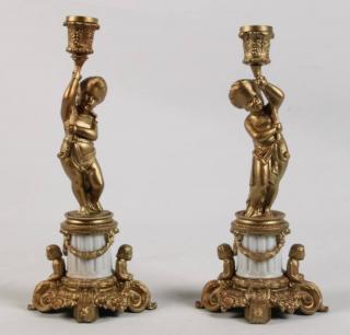 Appraisal: PAIR OF GILT METAL FIGURAL MOUNTED CANDLESTICKS WITH WHITE PORCELAIN