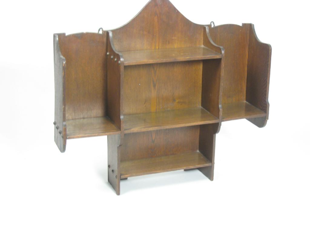 Appraisal: A Liberty and Co oak Wall Shelf with arched top