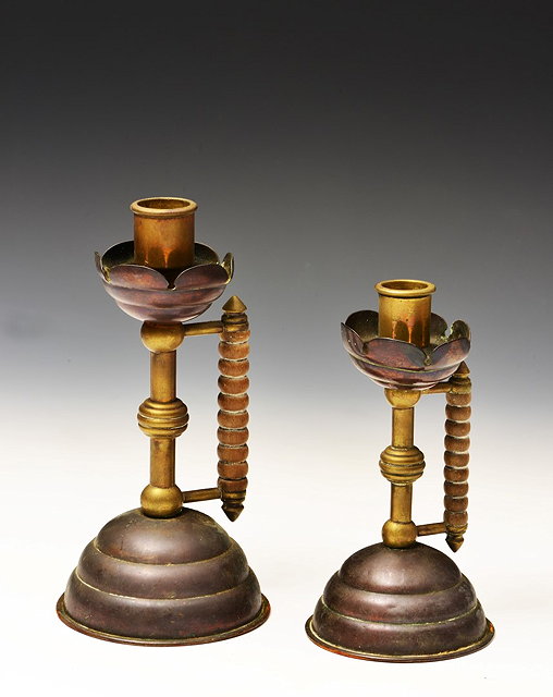 Appraisal: Two graduated Arts Crafts copper and brass candlesticks after designs