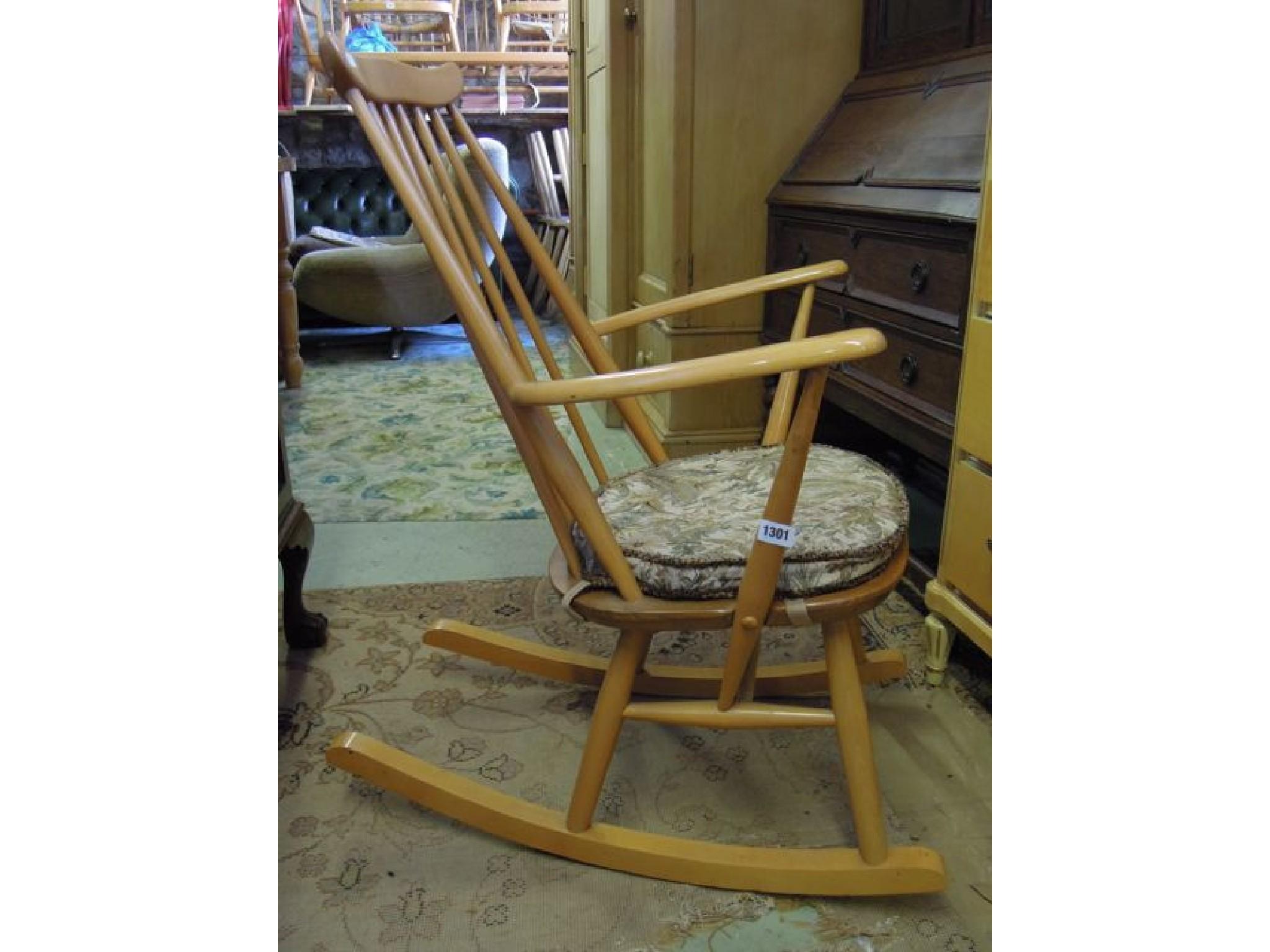 Appraisal: An Ercol light elm and beech wood stick back rocking