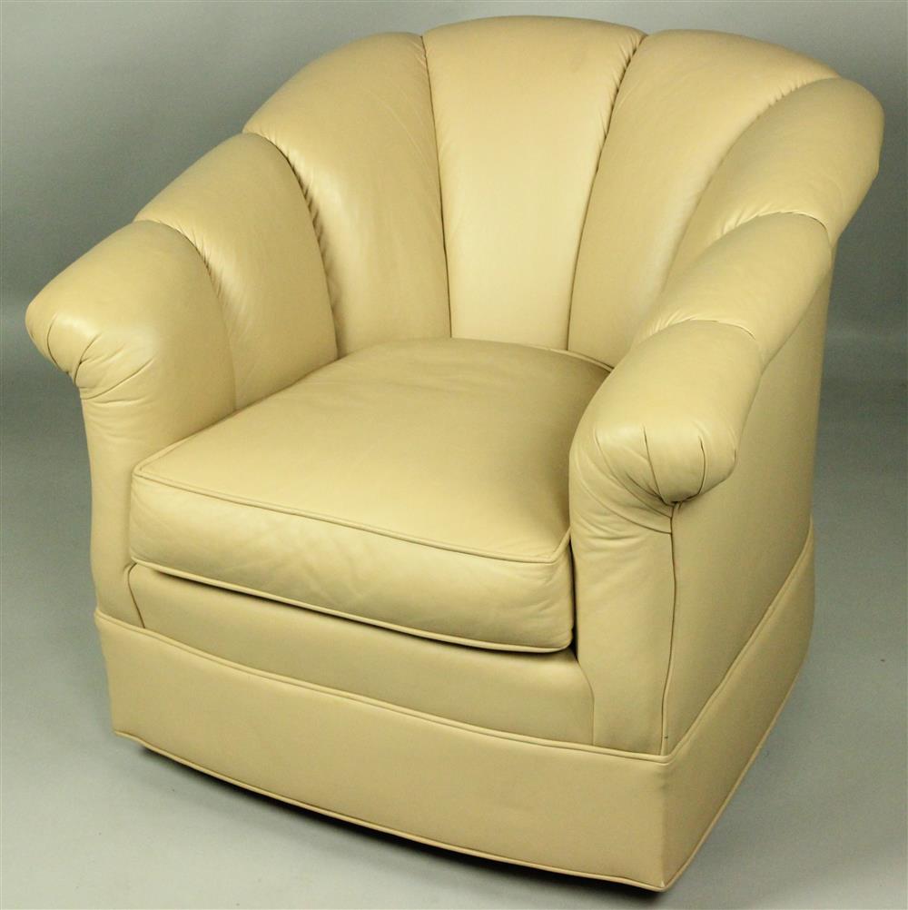 Appraisal: BEIGE LEATHER SWIVEL CLUB CHAIR the neatly upholstered chair atop