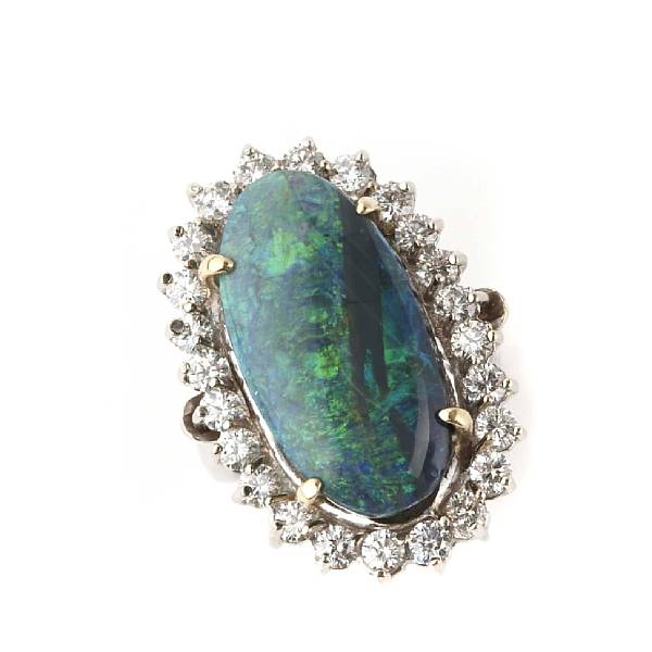 Appraisal: A black oval opal diamond and k gold ring estimated