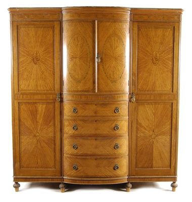 Appraisal: A late Victorian satinwood and marquetry breakfront wardrobe probably by