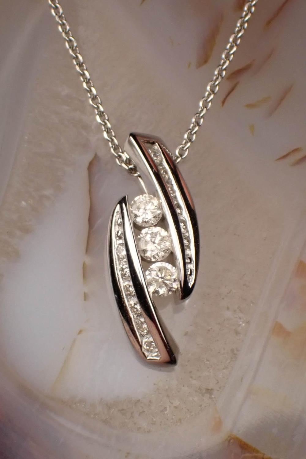 Appraisal: DIAMOND AND FOURTEEN KARAT GOLD PENDANT NECKLACE with a k