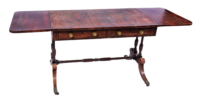 Appraisal: A REGENCY ROSEWOOD BRASS INLAID SOFA TABLE with drop ends