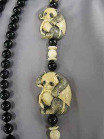 Appraisal: Carved Ivory Panda Bear Necklacewith black onyx beads '' long